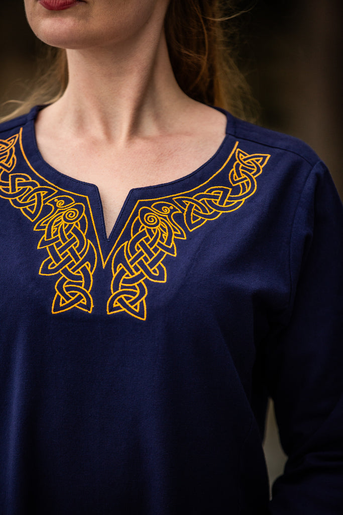 Close-up of embroidered neckline on blue cotton dress