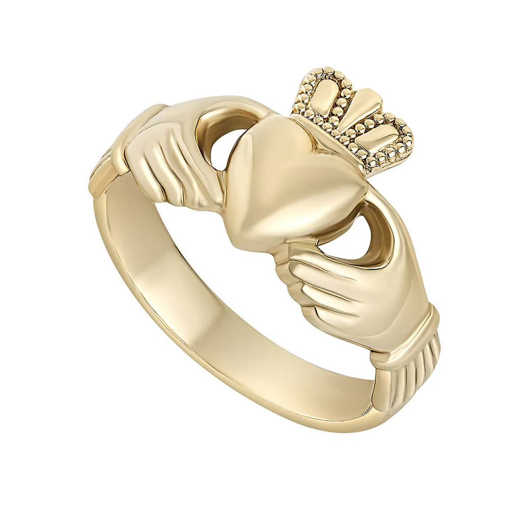 Gold Claddagh ring on a white background