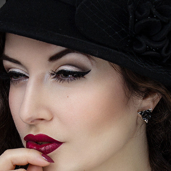 Black rose stud earrings crafted from fine English pewter and enamel, symbolizing dark romance in a compact, wearable design.